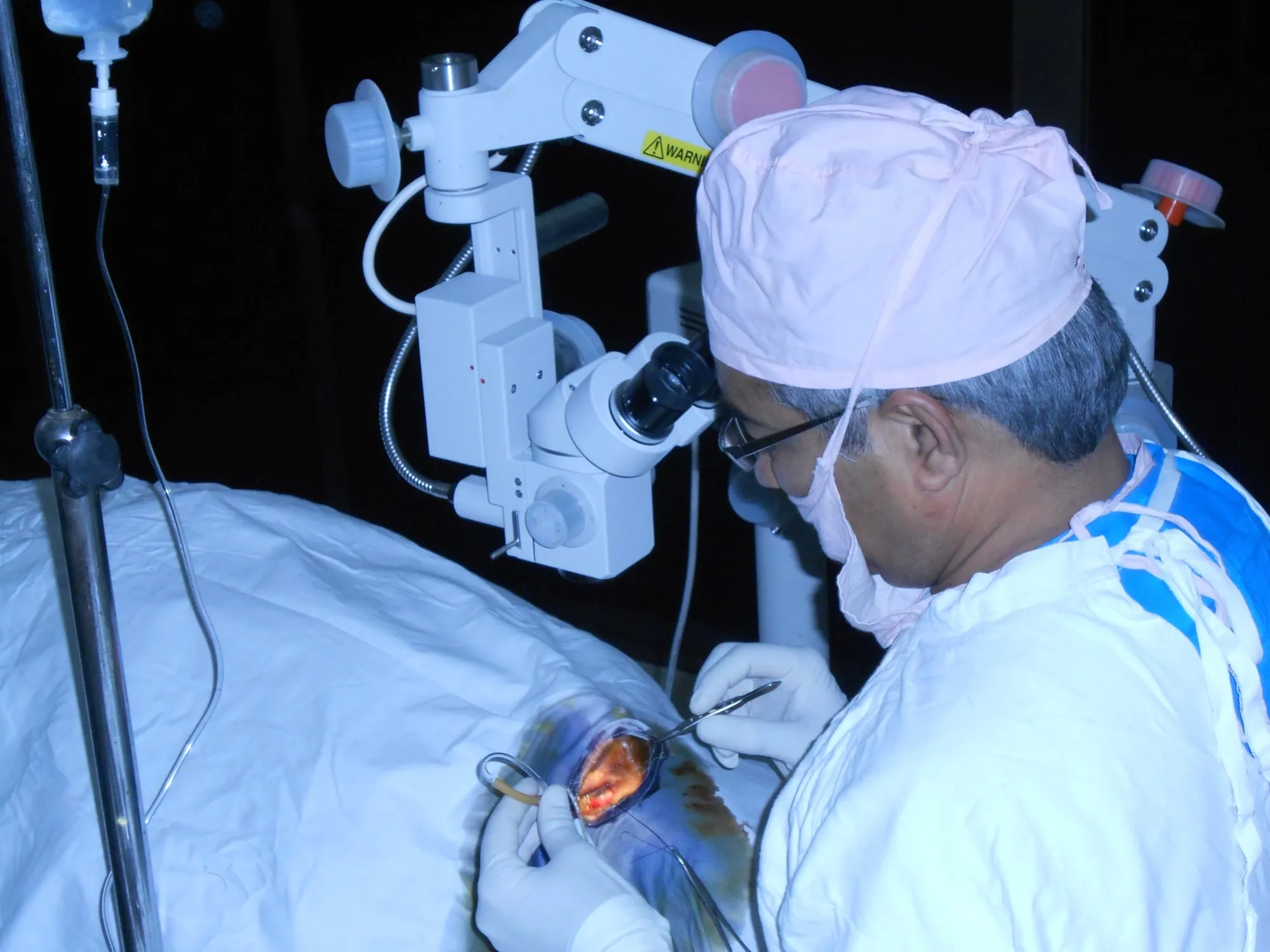 A surgeon performs a cataract operation using an operating microscope