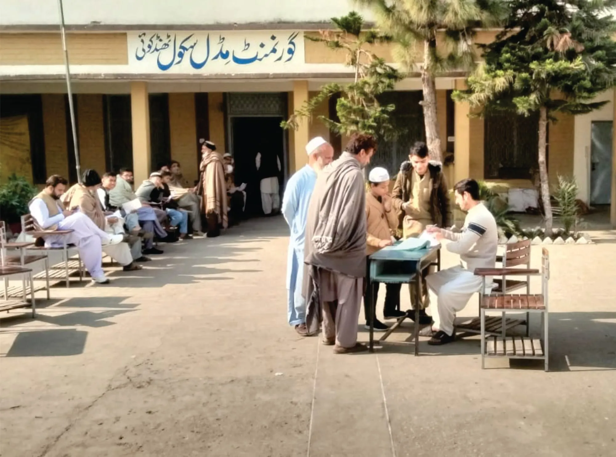 Patients waiting to be seen at a free eye camp in a village school