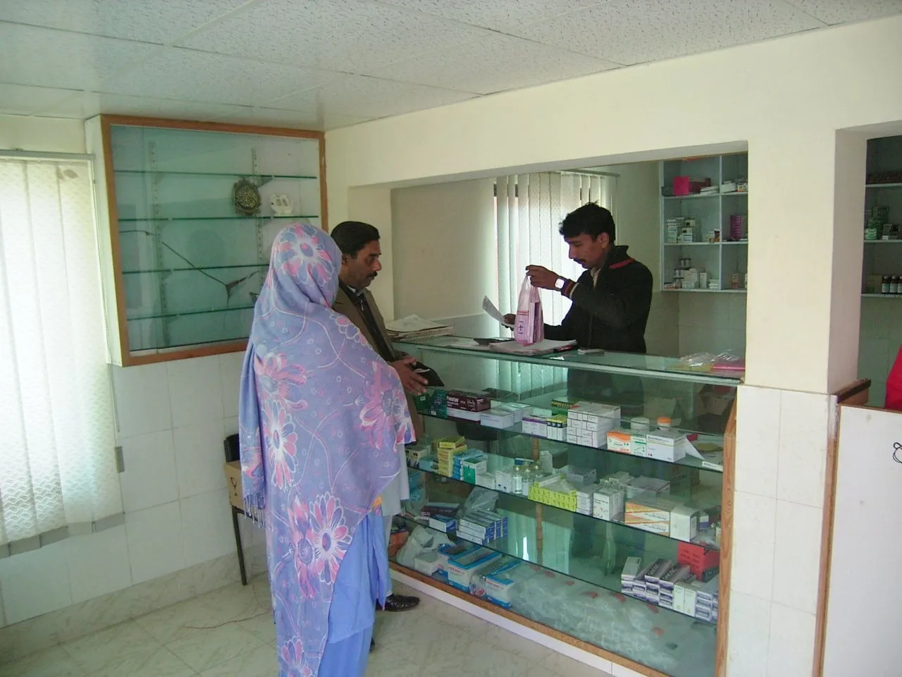 A patient collects medicines at the hospital pharmacy