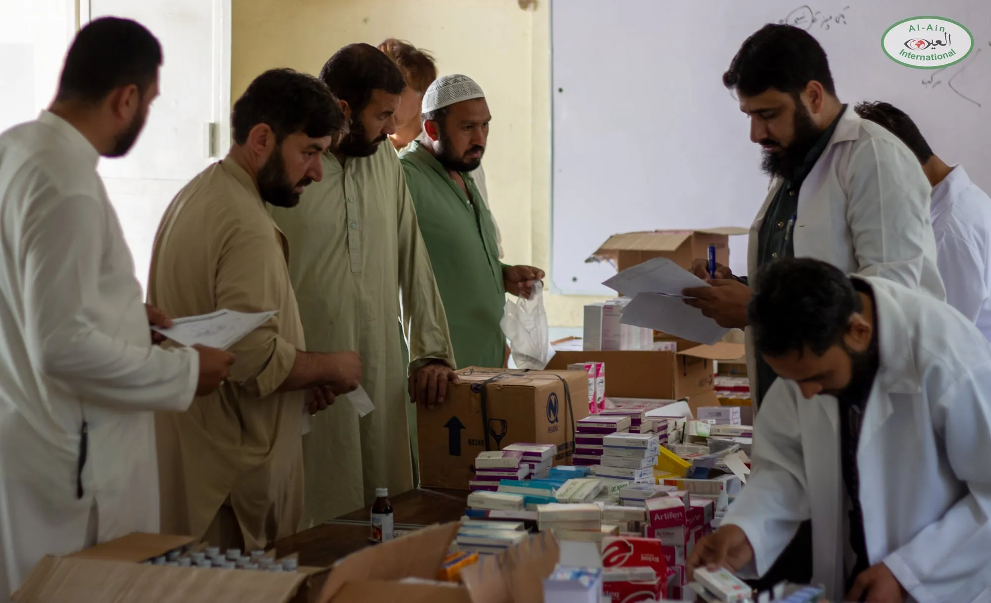 Doctors and volunteers sort medicines at the Swabi camp